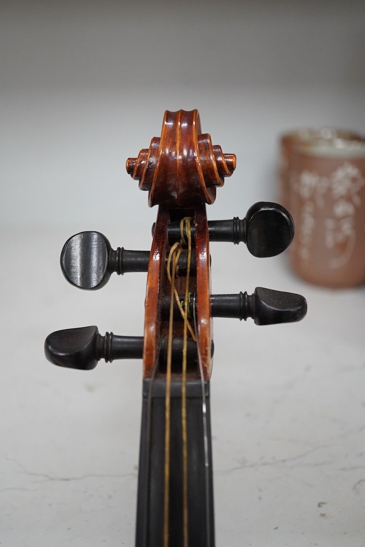 A late 19th century German violin after Pablo Maggini in bird’s eye maple with a fully mounted German bow in a crocodile skin case with retailers ivorine label reading; ‘Edward Withers, 22 Wardour Street, phone City 1899